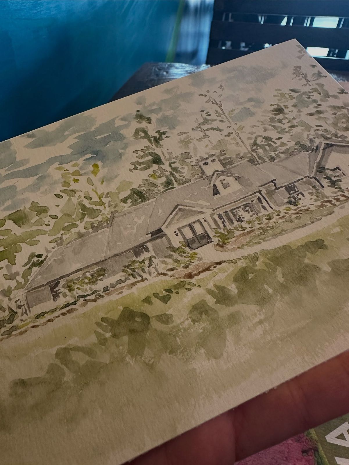 Watercolor portrait of a long low house beneath a large tree, shown at an angle